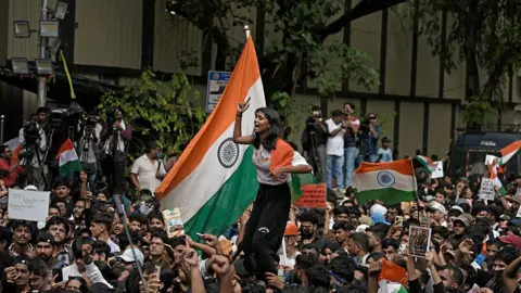 Modi spent years building his strong image - why is he making Gen Z reels now? NurPhoto via Getty Images Protesters raise slogans, hold placards and wave Indian flags during a demonstration in Mumbai, India, on July 24, 2026.
