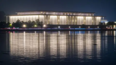 Getty Images The Kennedy Center is seen lit up in the dark across the Potomac River in Washington DC