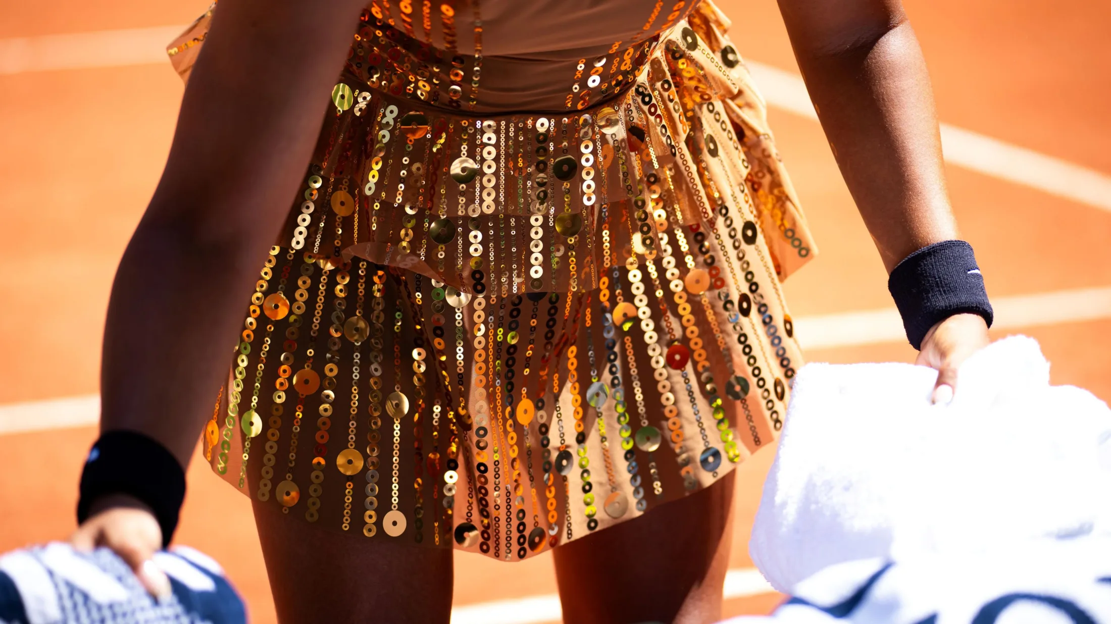 A close up of Naomi Osaka's gold dress at the French Open 