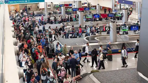 Trump says ICE agents will assist airport security as Dept of Homeland Security shutdown continues Getty Images Travellers stand in long lines which are snaking around baggage carousels at Atlanta Hartsfield-Jackson International Airport on March 22, 2026 in Atlanta, Georgia.