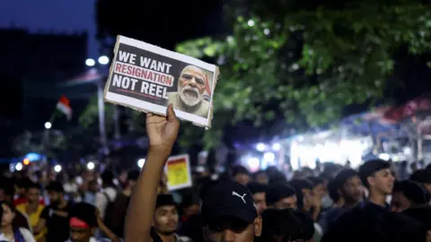 Modi spent years building his strong image - why is he making Gen Z reels now? Reuters A man holds a poster as he participates in a demonstration in Kolkata, India, July 24, 2026.