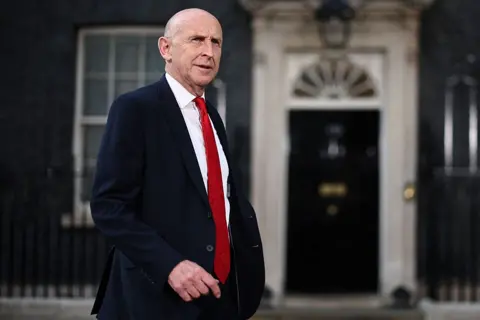 Getty Images Britain's former Defence secretary John Healey leaves 10 Downing Street in London as cabinet appointments are being made after Andy Burnham became Britain's new Prime Minister.