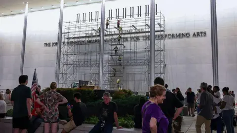 Getty Images People mill about in front of scaffolding on the front of the Kennedy Center