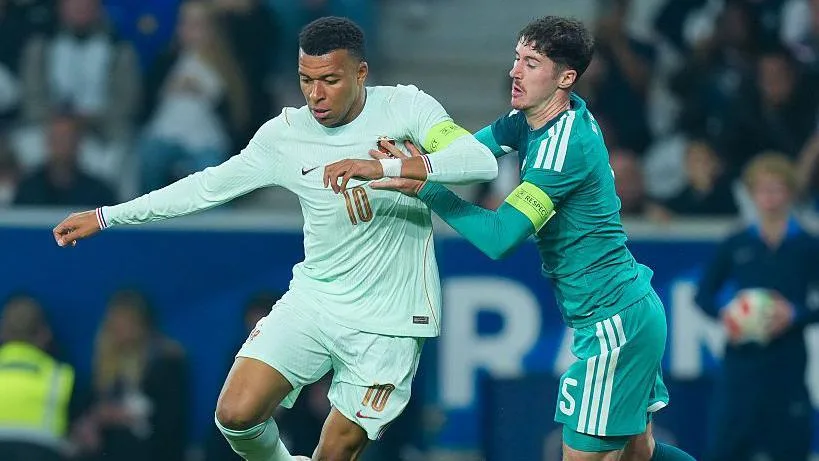 Olise scores hat-trick as France beat Northern Ireland Kylian Mbappe is tracked by NI captain Trai Hume