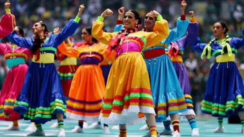 Reuters Dancers in colourful traditional Mexican dresses perform at the opening ceremony.