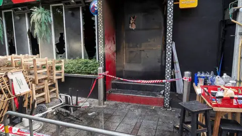 Getty Images Scorched debris and charred remnants litter the exterior grounds of the Lat Phrao entertainment venue