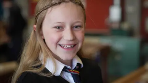 Secondary schools in Scotland cutting subjects due to teacher shortage 'crisis' Olivia smiling at the camera in a school classroom