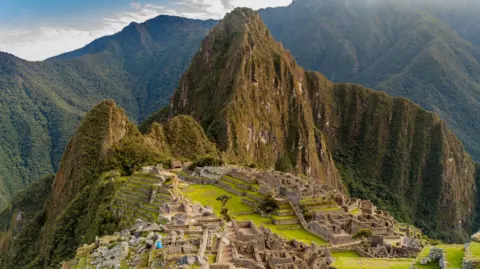 Australian man dies after falling down ravine on hike to Machu Picchu Getty Images Wide view of Machu Picchu with the ruins in the foreground and the mountains in the background