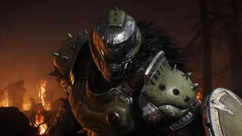 Xbox workers stunned after jobs 'bloodbath' ID Software Artwork showing the Doom Slayer, the main character from the Doom series. He leans towards the viewer, his hulking frame covered by battle-marked green armour, and his face obscured by his trademark helmet and visor. Fires burn in the background.