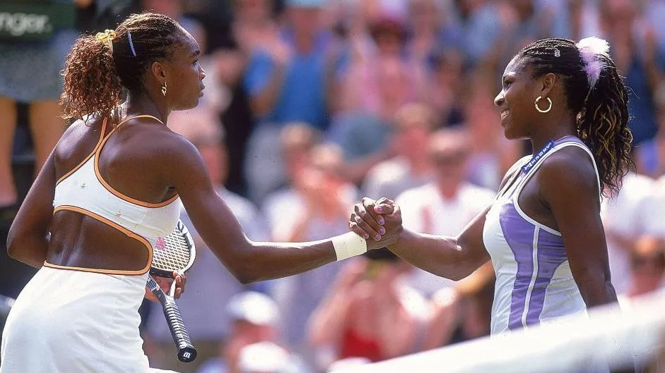Williams sisters receive Wimbledon doubles wildcard Venus and Serena Williams lock hands at the net after their 2000 Wimbledon semi-final