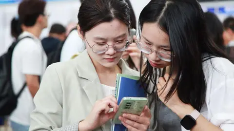 Getty Images Job seekers look for opportunities at a job fair majorly for overseas returnees and PhD holders in Nanjing in east China's Jiangsu province Saturday, Sept. 20, 2025. 