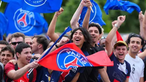 Getty Images Close up shot of PSG fans cheering and celebrating