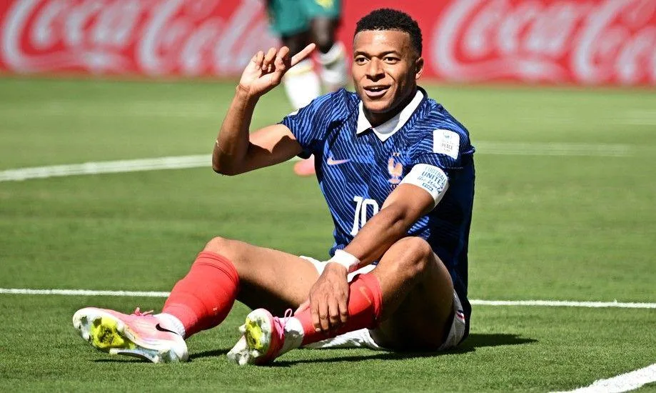 Kylian Mbappe reacts after a challenge by Sadio Mane inside the penalty area  during France's game with Senegal at the World Cup