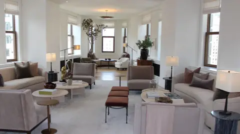 Would you pay $58.5m to live in this iconic New York building? Grace Eliza Goodwin View of triangular shaped apartment living room, with modern furniture, high ceiling, and windows all around
