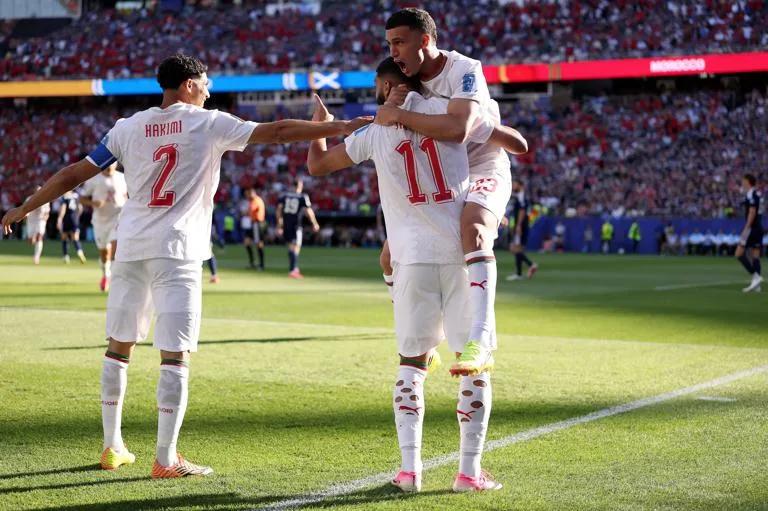 FOXBOROUGH, MASSACHUSETTS - JUNE 19: Ismael Saibari  #11 of Morocco celebrates with teammates Achraf Hakimi #2 and Bilal El Khannouss #23 after scoring his team's first goal during the FIFA World Cup 2026 Group C match between Scotland and Morocco at Boston Stadium on June 19, 2026 in Foxborough, Massachusetts. (Photo by Justin Setterfield/Getty Images)