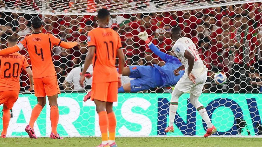 Issa Diop heads past Bart Verbruggen to equaliser for Morocco against Netherlands.