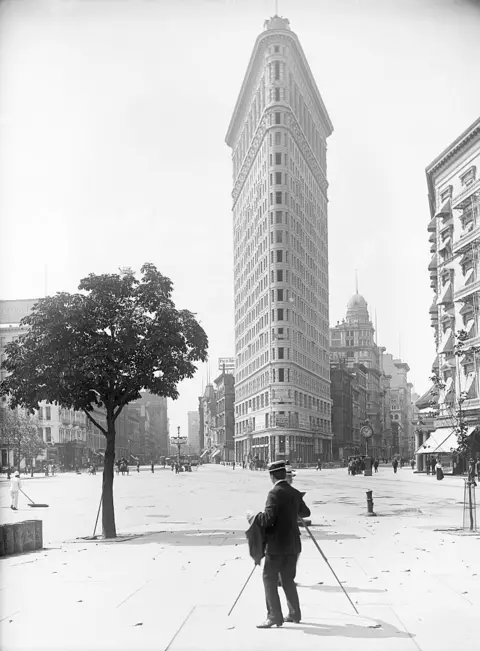 Would you pay $58.5m to live in this iconic New York building? Corbis via Getty Images historic black and white photo showing a photographer in front of triangular Flatiron Building