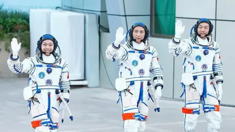 First Hong Kong astronaut launches into space onboard Chinese mission Getty Images Three Chinese astronauts wearing white space suits wave in front of a jubilant crowd waving Chinese flags ahead of the Shenzhou-23 launch