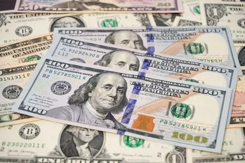 US government prepares to print $250 note featuring Trump's face LightRocket via Getty Images A collection of US dollar bills, with three $100 bills in the foreground featuring Benjamin Franklin, surrounded by other denominations.