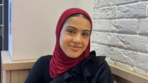 Young people out of work or training costing UK £125bn as report warns of 'perfect storm' Spear Zaynah wearing a burgandy headscarf and black top