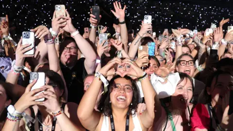Live Nation reaches settlement in US monopoly case Getty Images Fans watch Taylor Swift perform onstage during night two of Taylor Swift: The Eras Tour at La Defense on 10 May, 2024 in Paris, France.