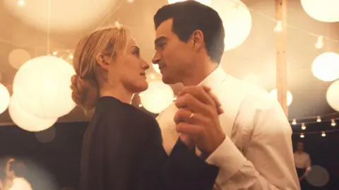 FX Sarah Pidgeon as Carolyn Bessette Kennedy dancing with Paul Kelly as John F Kennedy Jr in a still from Love Story