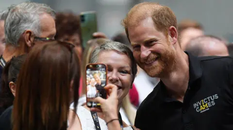 PA Media Prince Harry having a selfie taken with supporters of the Invictus Games in Birmingham