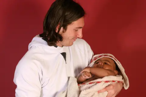 AP Lionel Messi cradles a baby Lamine Yamal in a bath in the away dressing room at Barcelona's Camp Nou stadium in 2007