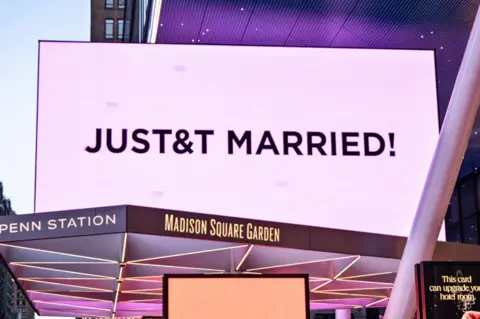 Taylor Swift and Travis Kelce wed in NYC in ceremony officiated by Adam Sandler EPA Madison Square Garden is lit in pink and displays a sign reading 'JUST&T MARRIED' during Taylor Swift and Travis Kelce's wedding celebration in New York, New York, USA, 3 July 2026.