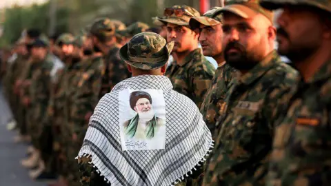Saudi Arabia joins US in strikes on Iran-backed militias in Iraq AFP A member of Iraq's Popular Mobilisation Forces (PMF) wears a keffiyeh scarf with a portrait of Iran's late Supreme Leader Ali Khamenei stuck to it, at the shrine of Imam Hussein on the eve of his funeral ceremonies in the holy Iraqi city of Karbala (7 July 2026)