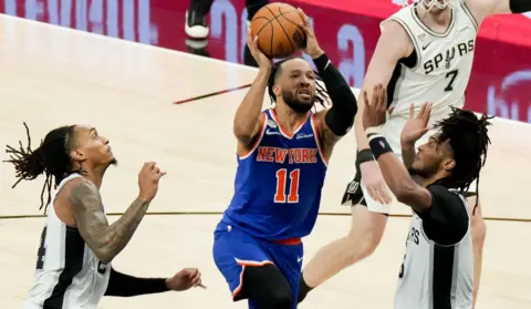 Scott Wachter-Imagn Images New York Knicks guard Jalen Brunson (11) shoots against San Antonio Spurs guard Stephon Castle (5) in the first half during game five of the 2026 NBA Finals in Texas.