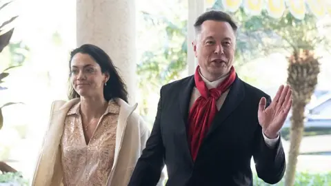 Former OpenAI board member says Elon Musk offered her sperm donations AFP via Getty Images Shivon Zilis wearing a pale dress and jacket, with Elon Musk wearing a suit and red scarf. Both are smiling and Musk is waving.
