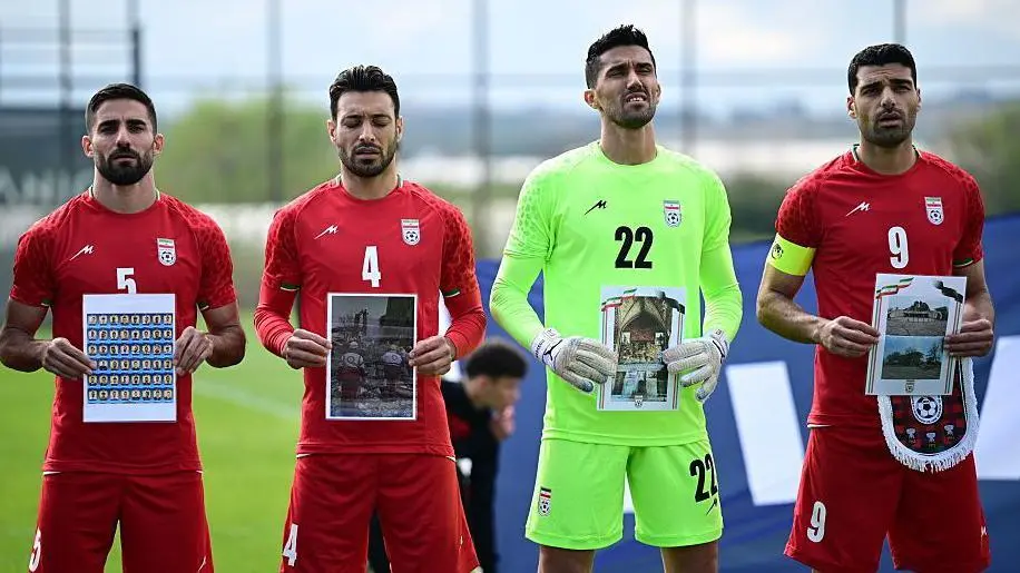 Iran national football team players hold photos of children killed in war as well as damaged hospitals and historical buildings ahead of Tuesday's game against Costa Rica in Turkey