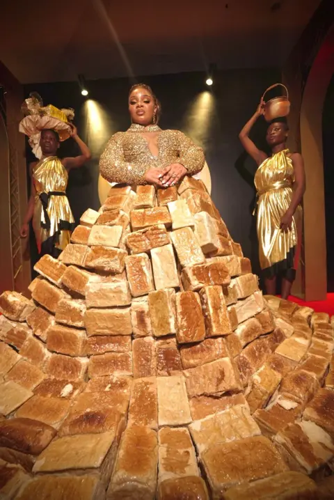 Dress made from 500 loaves stuns Africa Magic Viewers' Choice Awards BBC/GIFT UFUOMA Reality TV star Queen Mercy Atang is seen with her dress made from loaves of bread