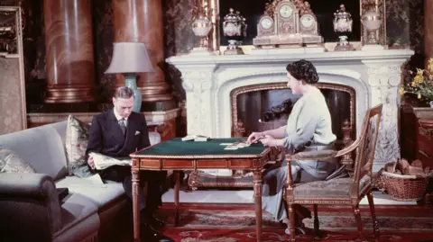 Getty Images King George VI and Queen Elizabeth entertain themselves during a quiet moment at Buckingham Palace, London, in 1942