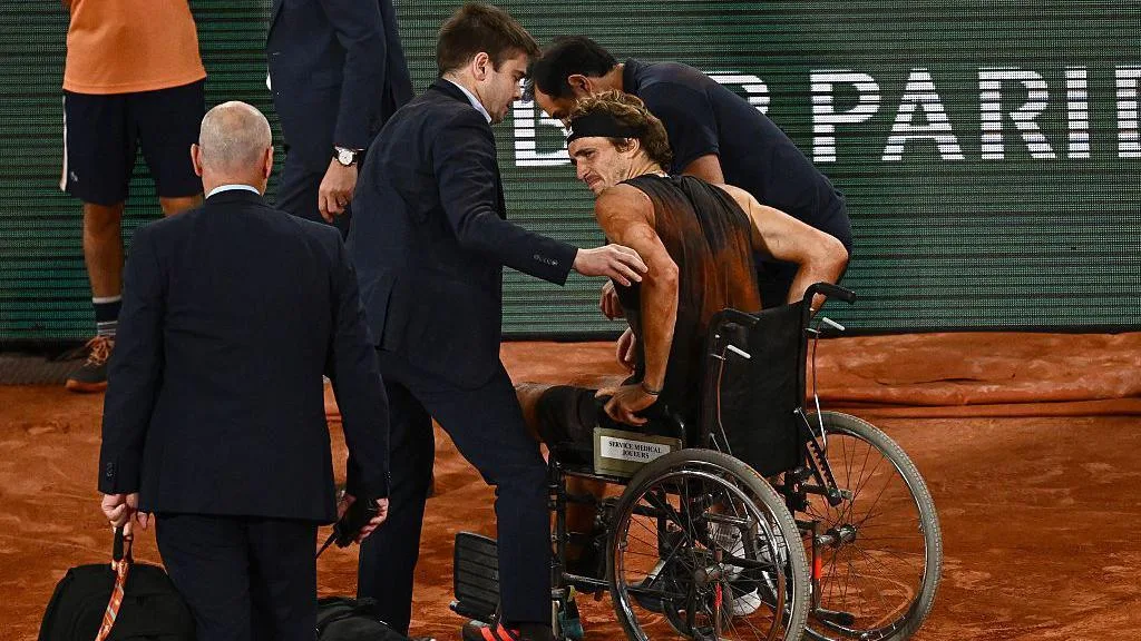 Alexander Zverev leaves Court Philippe-Chatrier in a wheelchair