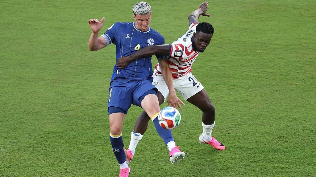 Folarin Balogun of the United States fouls Tarik Muharemovic of Bosnia and Herzegovina which is later reviewed by VAR and awarded as a red card foul