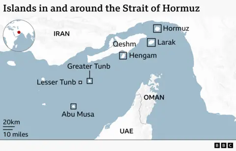 A map of the Strait of Hormuz showing the surrounding coasts of Iran to the north and Oman and the UAE to the south. Several islands in the strait are labelled, including Hormuz, Larak, Qeshm, and Hengam near Iran, and Greater Tunb, Lesser Tunb, and Abu Musa further southwest. A small inset globe highlights the region’s location.