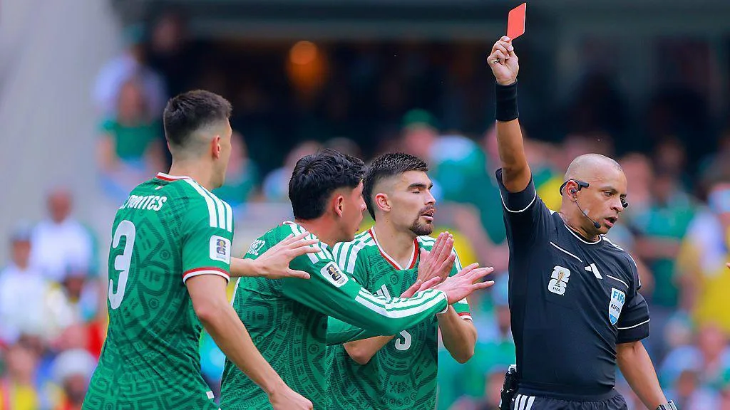 Mexico's Cesar Montes is shown a red card