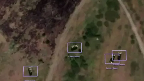 OpenAI changes deal with US military after backlash BBC/Palantir A picture showing a satellite image of military vehicles each covered with a purple box labelled "enemy asset".