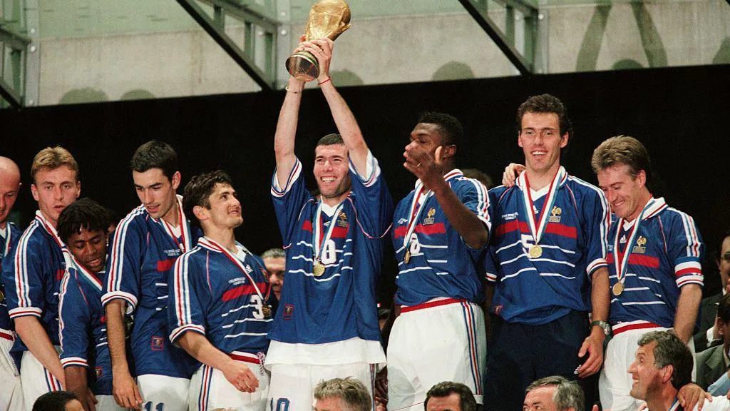 'Extremely happy' Deschamps gets the farewell game no-one wants Zinedine Zidane holds the World Cup aloft in 1998 with captain Didier Deschamps among the France team-mates surrounding him