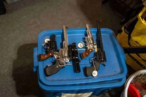Ex-Canada MP arrested after police seize 439 guns and antique cannon from his home RCMP Small firearms are laid on a blue container and tagged in a Dauphin, Manitoba home.