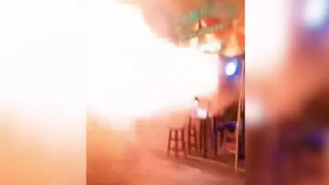 Fire & Rescue Thailand A still from a video showing a fireball shooting out of the venue