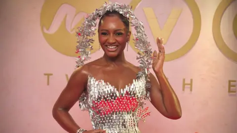 Dress made from 500 loaves stuns Africa Magic Viewers' Choice Awards BBC/GIFT UFUOMA Actor and event host Simi Drey is draped in starlight, in a dress entirely made from glass designed by Ovems