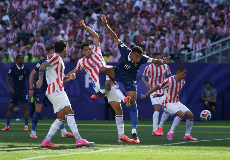 PHILADELPHIA, PENNSYLVANIA - JULY 04: Kylian Mbappe #10 of France competes for the ball against Diego Gomez #8 of Paraguay during the FIFA World Cup 2026 Round of 16 match between Paraguay and France at Philadelphia Stadium on July 04, 2026 in Philadelphia, Pennsylvania. (Photo by Buda Mendes/Getty Images)