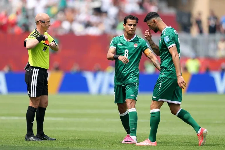 TORONTO, ONTARIO - JUNE 26: Rebin Ghareeb #2 of Iraq is consoled by Ibrahim Bayesh #8 of Iraq after receiving a red card by Referee Anthony Taylor after the VAR review during the FIFA World Cup 2026 Group I match between Senegal and Iraq at Toronto Stadium on June 26, 2026 in Toronto, Ontario. (Photo by Joosep Martinson - FIFA/FIFA via Getty Images)