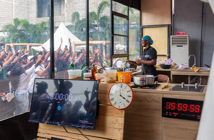 Hilda doing her cooking marathon with a crowd watching