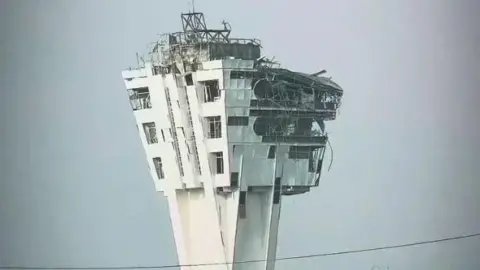 Instagram A large control tower is shown with windows blown out and the exterior crumbling