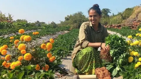 India wants to join the strawberry superpowers Sheetal Danavle Sheetal Danavle crouches in a field, surrounded by flowers.