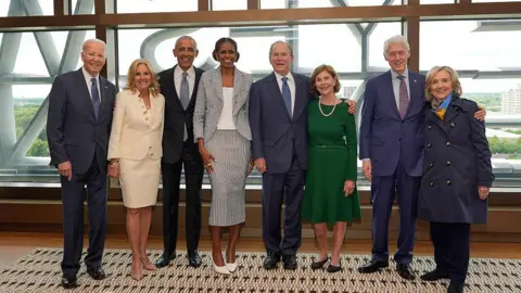 Getty Images Former President Joe Biden and former first lady Jill Biden, from left, former President Barack Obama and former first lady Michelle Obama, former President George W. Bush and former first lady Laura Bush, and former President Bill Clinton and former Secretary of State Hillary Clinton pose ahead of the dedication ceremony for the opening of the Barack Obama Presidential Center, in John Lewis Plaza, on June 18, 2026 in Chicago, Illinois. Barack Obama served as the 44th president of the United States from 2009 to 2017 and was the first African American to hold the office. 

